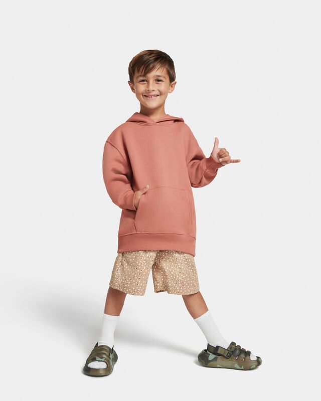 A shot of a little boy wearing the UGG Sport Yeah Camopop sandal against a white background.